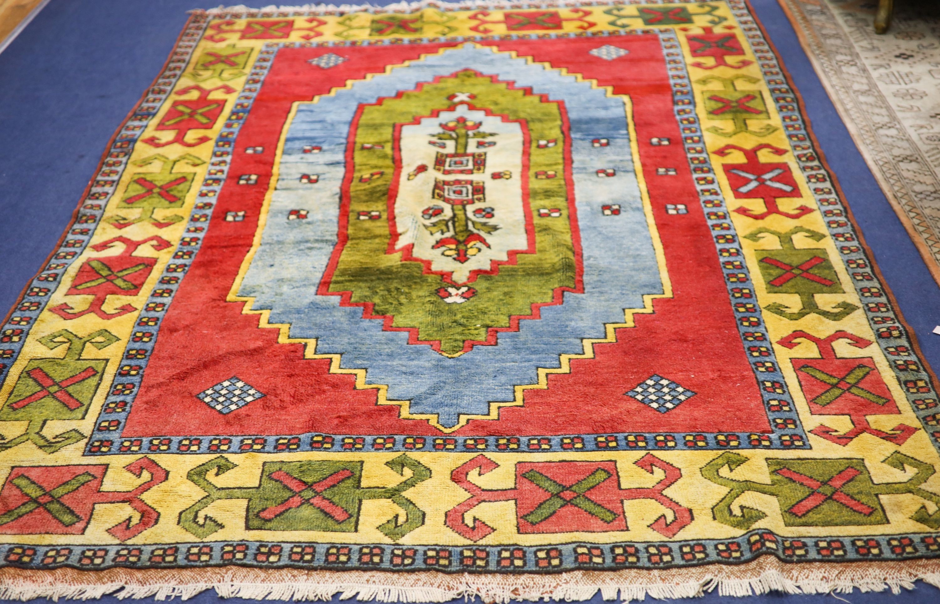 A Caucasian style red ground carpet, 290 x 200cm